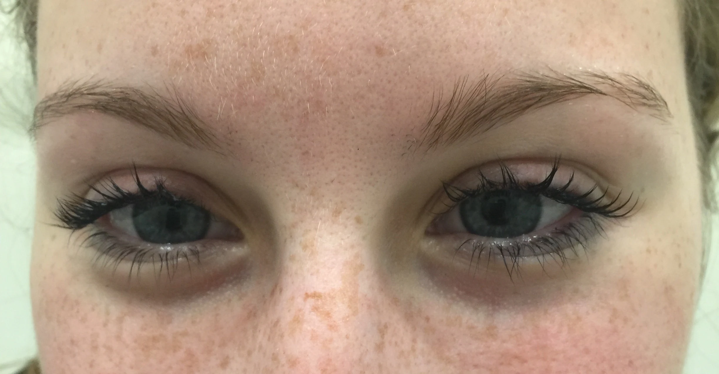Straight-on close-up of both eyes with full lash extensions applied